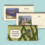 Three illustrated calendars featuring strange and bizarre animals on a light blue background.