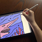Hand holding a stylus over a digital drawing of a goblin shark on a tablet screen.