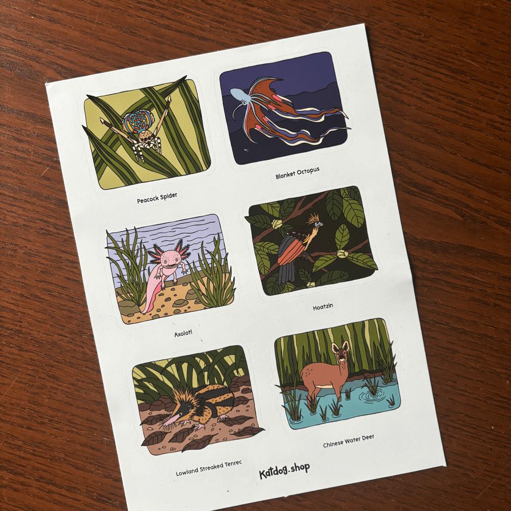 Sheet of illustrated stickers featuring various animals on a wooden surface
