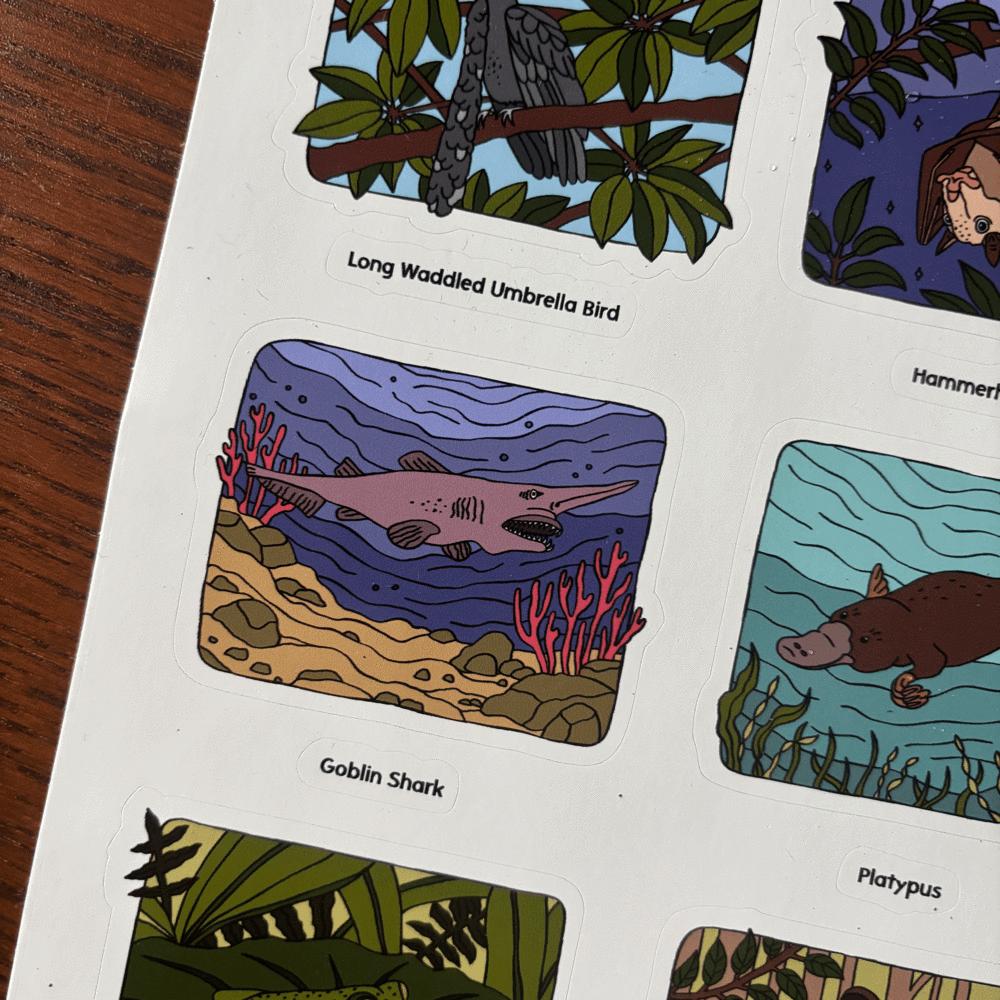 sticker sheet with illustrations of a goblin shark, platypus, and other animals on a white background.